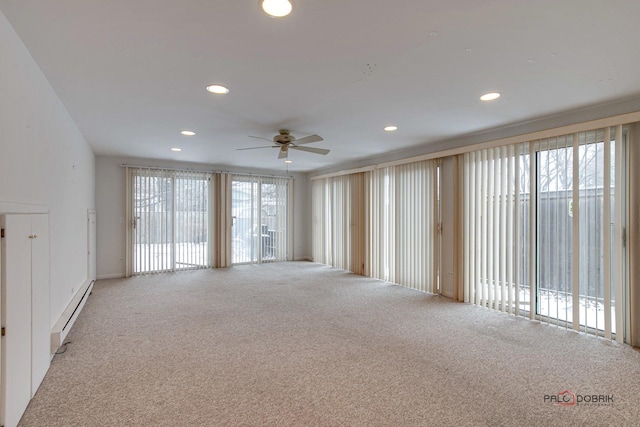 unfurnished room featuring carpet, a baseboard radiator, and ceiling fan