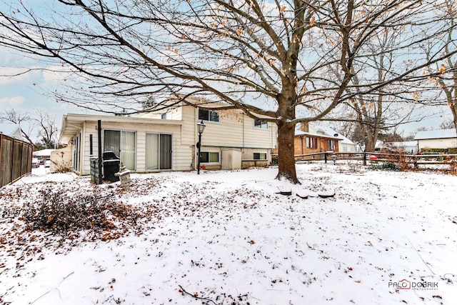 view of snow covered rear of property