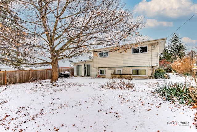 view of snow covered rear of property