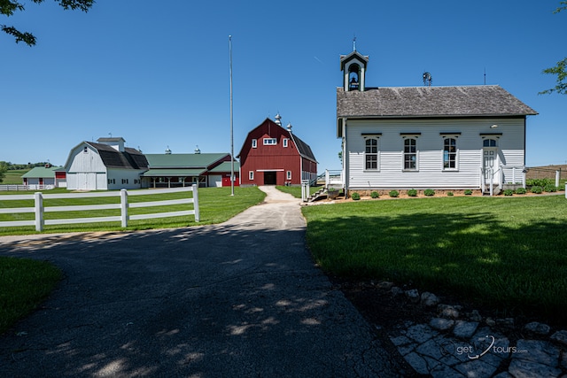 exterior space featuring an outdoor structure and a lawn