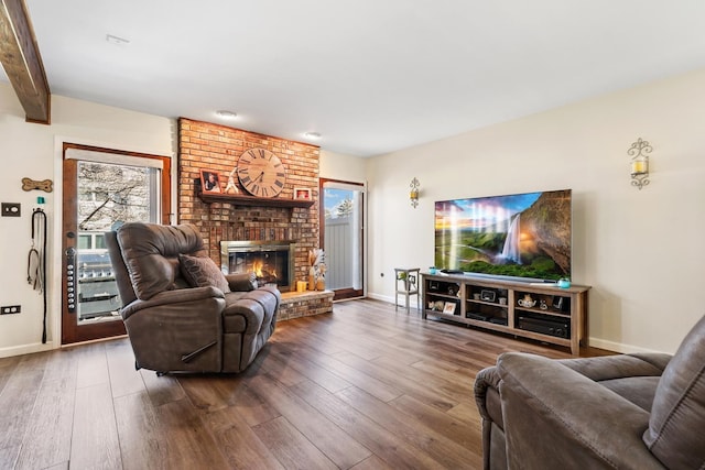 living room with a fireplace and dark wood-type flooring