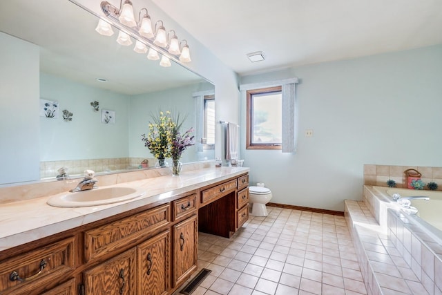 bathroom featuring tile patterned flooring, vanity, a relaxing tiled tub, and toilet