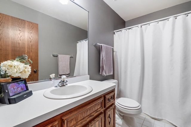 bathroom with tile patterned floors, vanity, and toilet