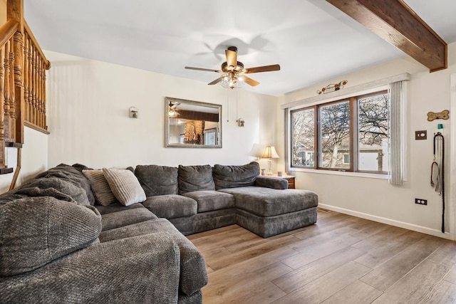 living room with hardwood / wood-style flooring, ceiling fan, and beam ceiling