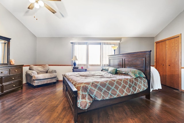 bedroom featuring ceiling fan, a closet, dark hardwood / wood-style flooring, and vaulted ceiling