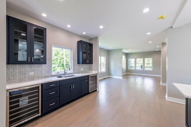 kitchen with a healthy amount of sunlight, sink, and beverage cooler