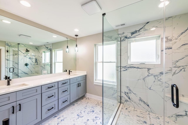 bathroom featuring walk in shower, vanity, and plenty of natural light