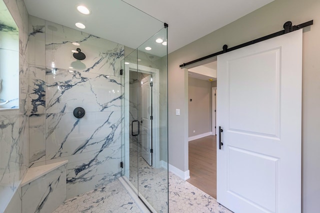 bathroom with hardwood / wood-style floors and an enclosed shower