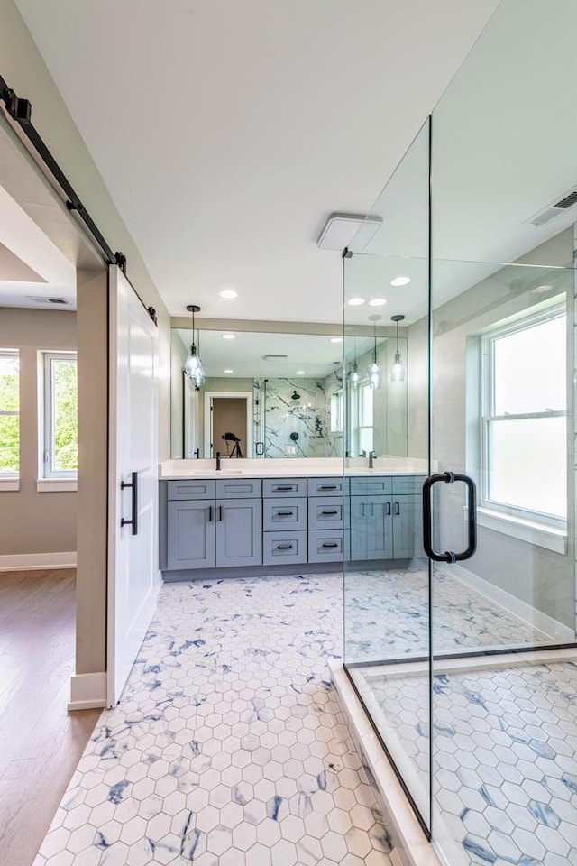 bathroom with vanity and a shower with shower door