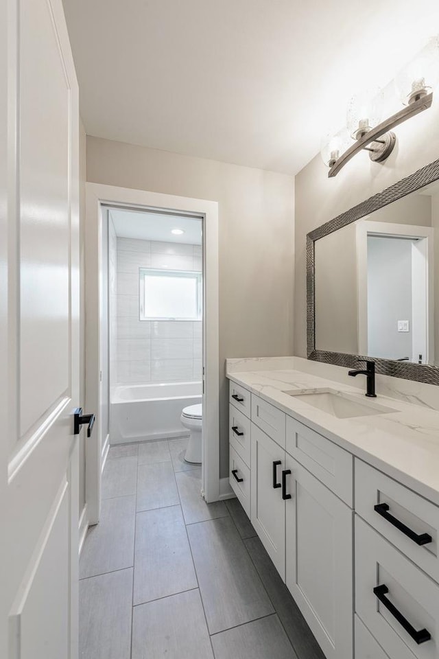 full bathroom with vanity, toilet, and tiled shower / bath combo