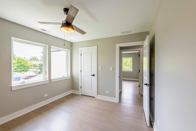 unfurnished bedroom with ceiling fan and light hardwood / wood-style flooring