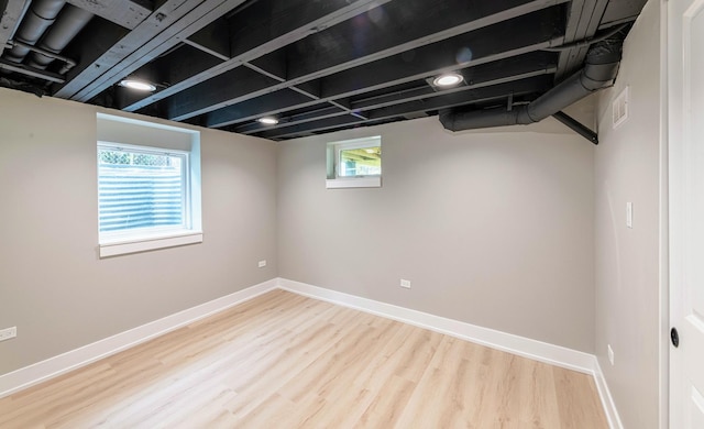 basement featuring wood-type flooring and a wealth of natural light