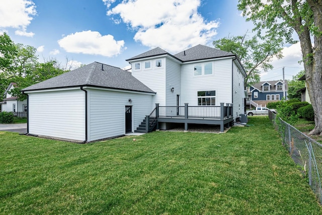 back of house featuring a deck, central AC unit, and a lawn