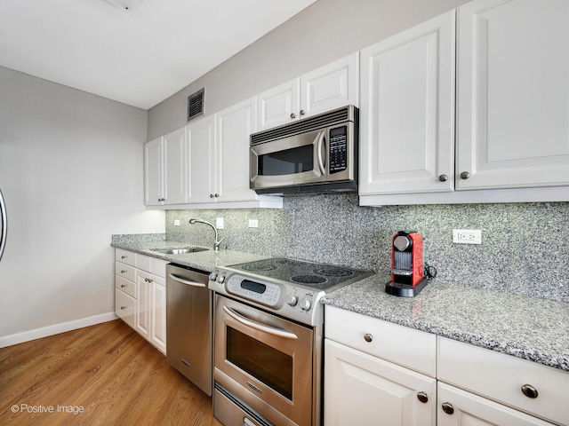 kitchen with white cabinets, sink, and appliances with stainless steel finishes