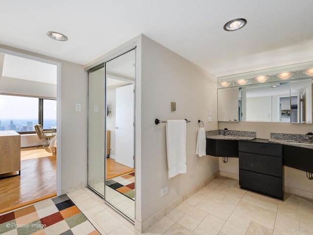 bathroom with tile patterned flooring and vanity