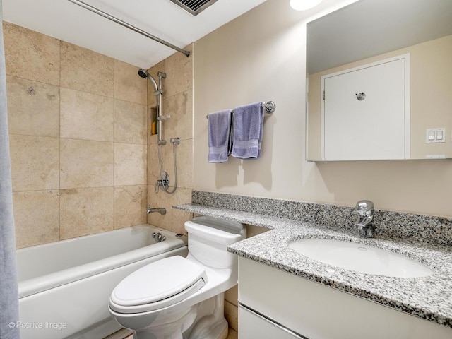 full bathroom featuring vanity, toilet, and tiled shower / bath