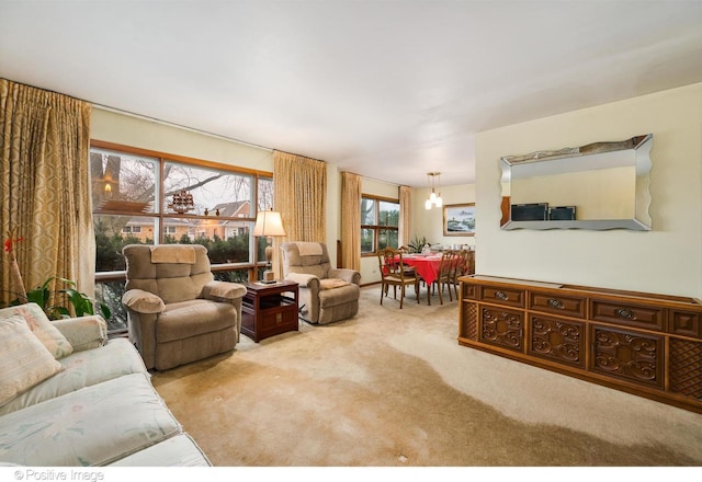 carpeted living room with a notable chandelier