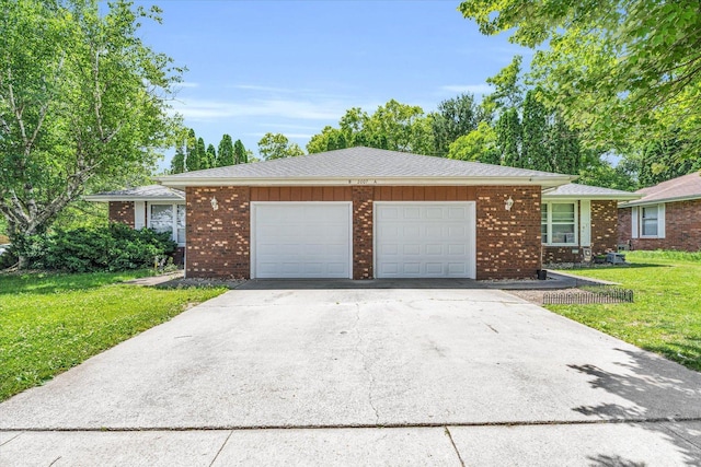 single story home featuring a garage, driveway, and a front lawn