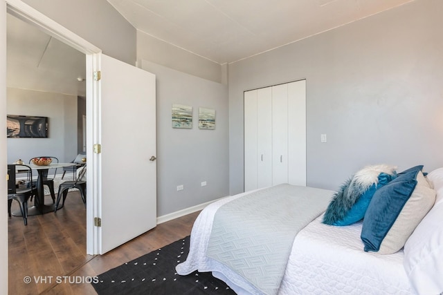 bedroom with a closet and dark hardwood / wood-style floors