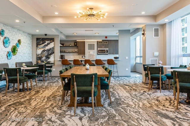 dining area featuring an inviting chandelier