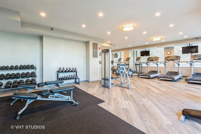 exercise room featuring light wood-type flooring