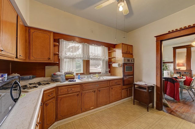 kitchen with ceiling fan, white gas stovetop, and sink