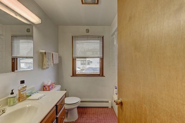 bathroom featuring a bath, vanity, toilet, and baseboard heating