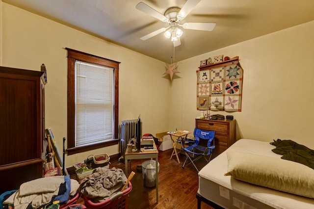 bedroom featuring ceiling fan and dark wood-type flooring