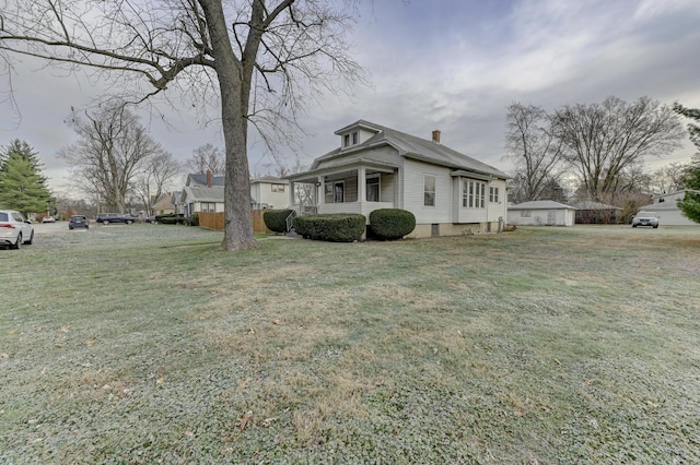 view of side of home with a yard