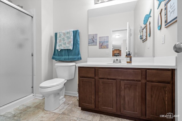 bathroom featuring vanity, an enclosed shower, and toilet