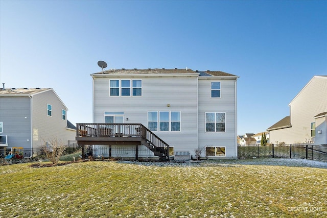 back of property featuring a lawn and a wooden deck