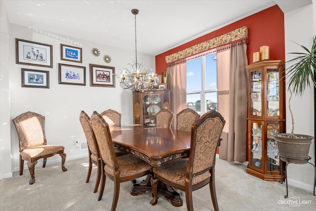 carpeted dining space with a notable chandelier