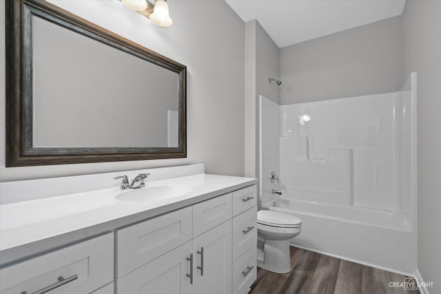 full bathroom featuring shower / tub combination, hardwood / wood-style floors, vanity, and toilet