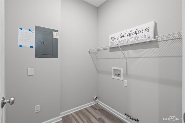 laundry room with hardwood / wood-style floors, hookup for a washing machine, gas dryer hookup, and electric panel