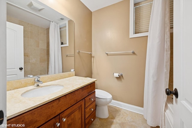 bathroom featuring toilet, vanity, baseboards, and tile patterned floors