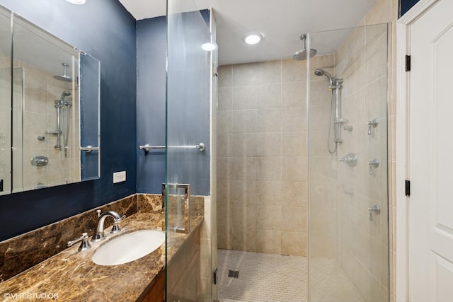 bathroom featuring a shower stall and vanity