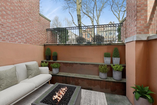 view of patio / terrace featuring an outdoor living space with a fire pit