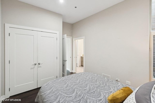 bedroom featuring dark hardwood / wood-style floors and a closet