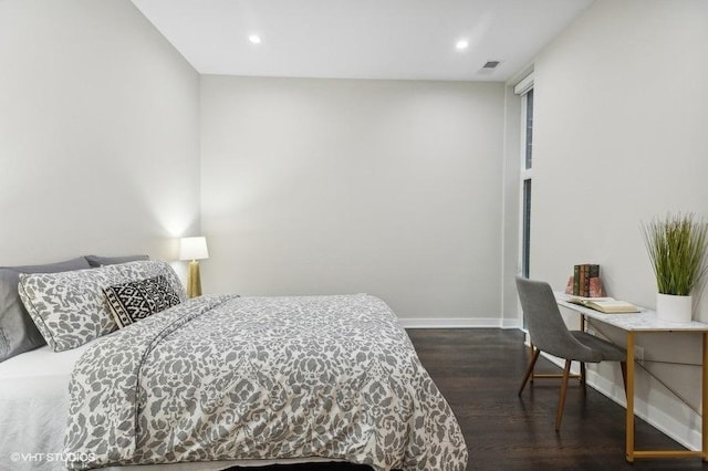 bedroom with dark hardwood / wood-style floors