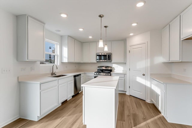 kitchen with a center island, white cabinetry, sink, and appliances with stainless steel finishes