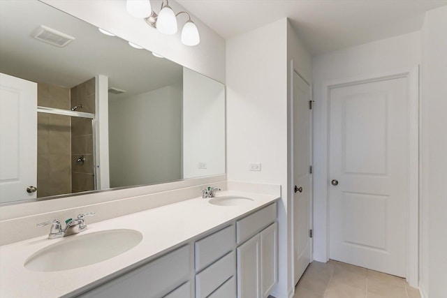 bathroom with tile patterned floors, vanity, and walk in shower