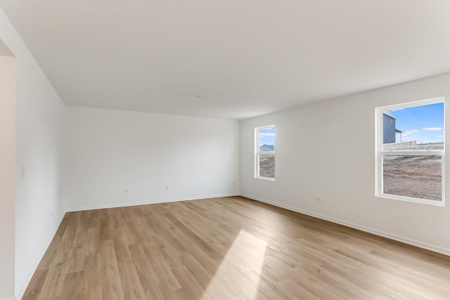 unfurnished room featuring light hardwood / wood-style floors