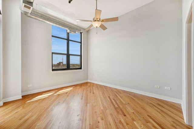 spare room with ceiling fan and light wood-type flooring