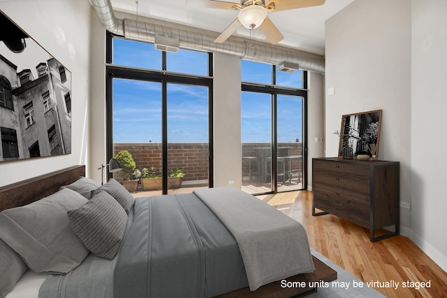 bedroom with floor to ceiling windows, ceiling fan, light hardwood / wood-style flooring, and access to exterior