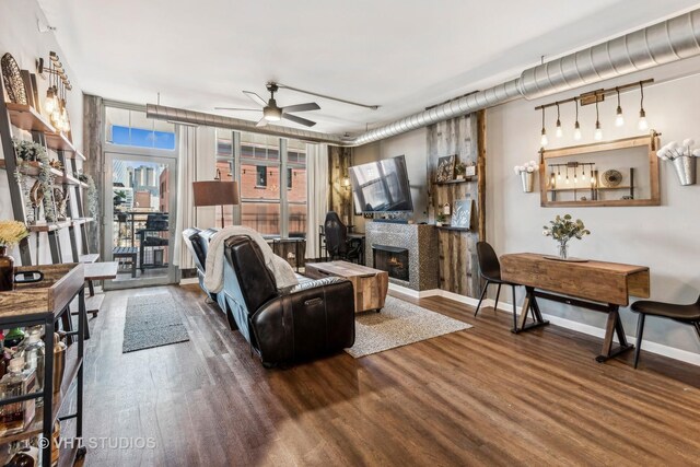 living room with ceiling fan and dark wood-type flooring