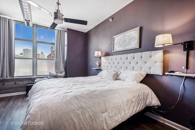 bedroom with dark wood-type flooring and ceiling fan