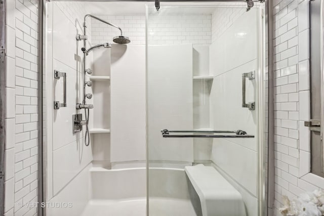 bathroom featuring a shower with shower door