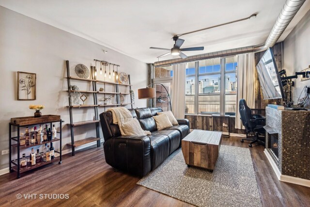 living room featuring ceiling fan and dark hardwood / wood-style floors