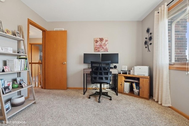 office space with carpet flooring, visible vents, and baseboards