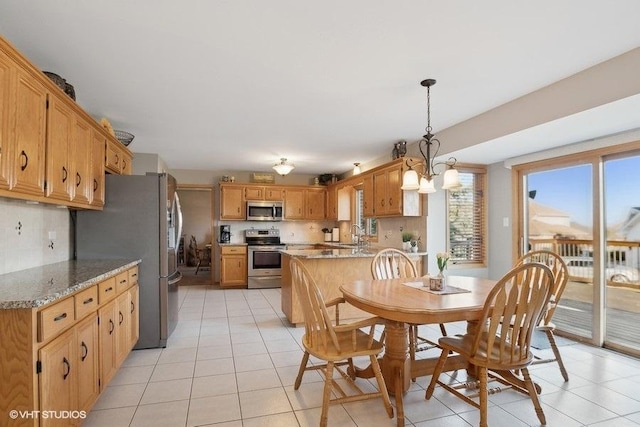 dining space featuring light tile patterned floors and a notable chandelier